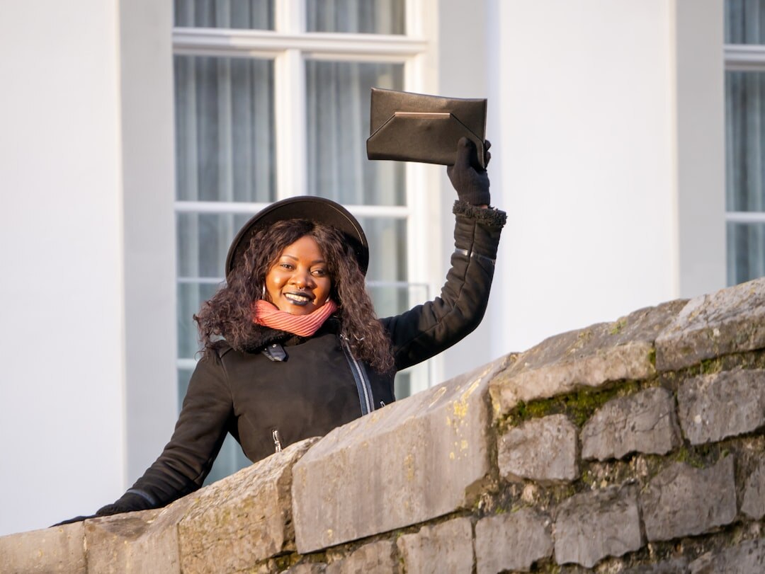 Belgian marketing professional smiling while holding a tablet
